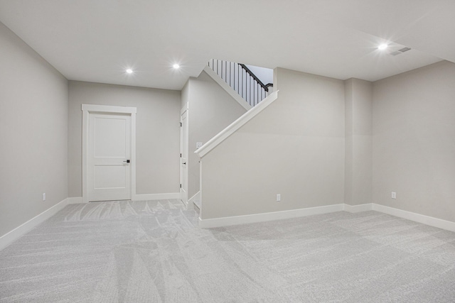 basement featuring light colored carpet