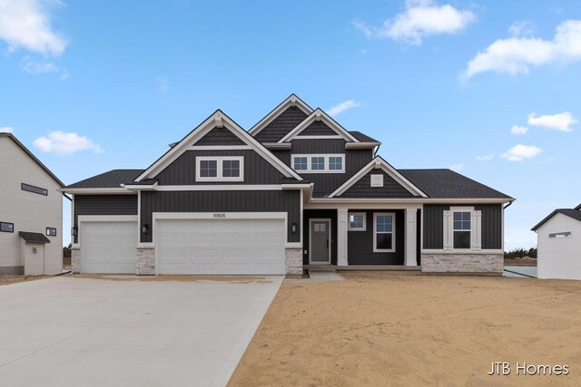 craftsman house featuring concrete driveway and board and batten siding