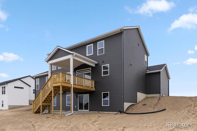 rear view of house with a deck and stairs