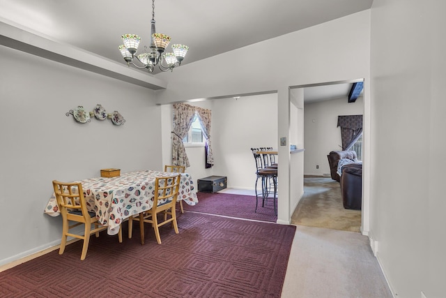 dining room featuring carpet flooring and a chandelier