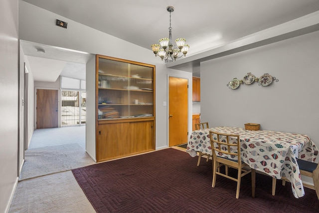 dining space with carpet, vaulted ceiling, and a notable chandelier