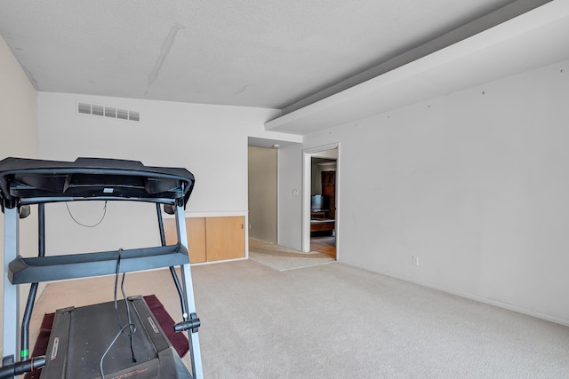 workout room featuring carpet flooring, a textured ceiling, and vaulted ceiling