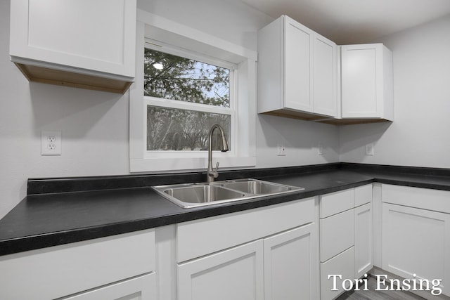 kitchen featuring sink and white cabinets