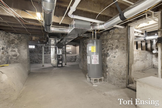 basement featuring heating unit and water heater