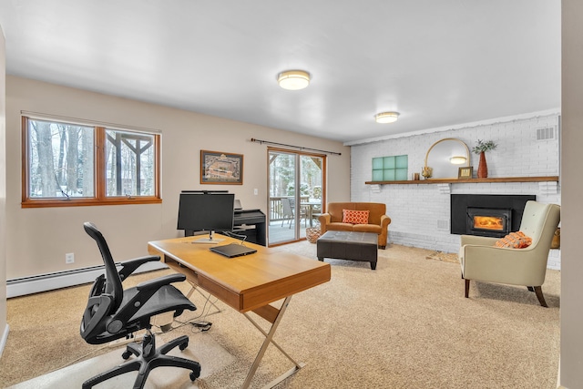 office area featuring baseboard heating, a brick fireplace, carpet floors, and brick wall