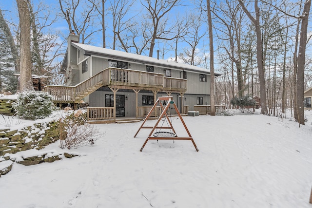 snow covered property featuring a wooden deck and cooling unit