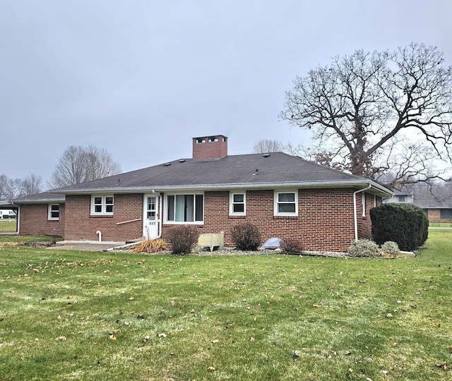 rear view of property with a lawn and a patio