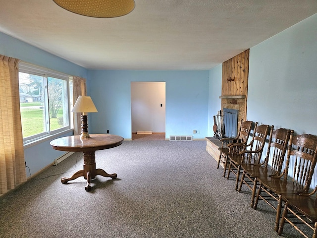 living area with a fireplace and carpet