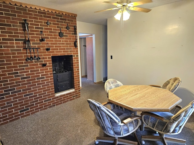 carpeted dining area with ceiling fan and a wood stove