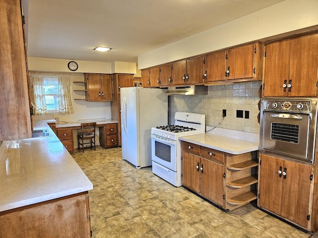 kitchen featuring decorative backsplash and white appliances