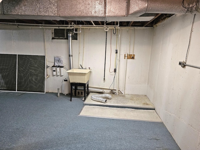 basement featuring carpet floors and sink