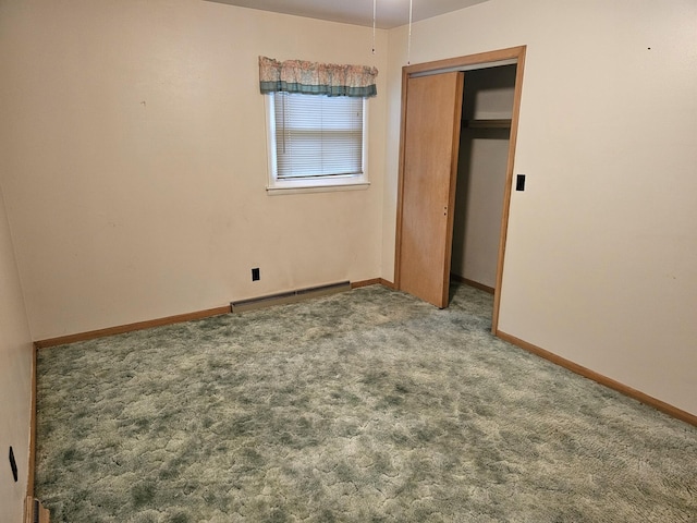 unfurnished bedroom with a closet, carpet floors, and a baseboard radiator