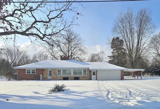 ranch-style home with cooling unit, a carport, and a garage