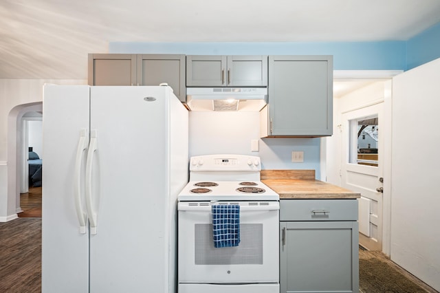 kitchen with gray cabinetry, white appliances, and dark wood-type flooring