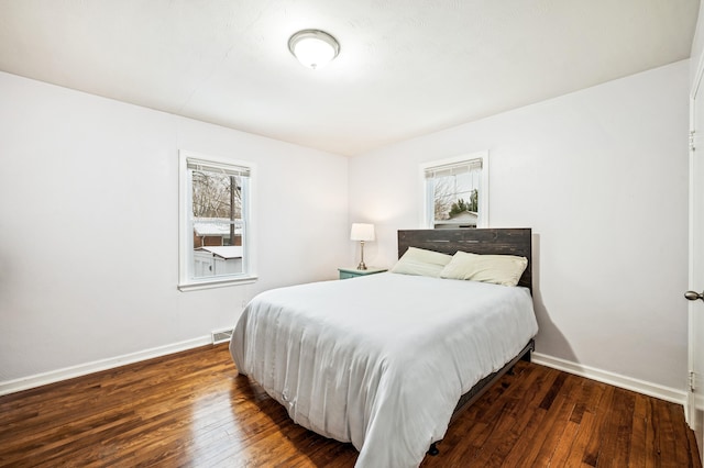 bedroom with dark wood-type flooring