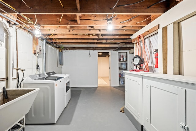 basement with washing machine and dryer and sink