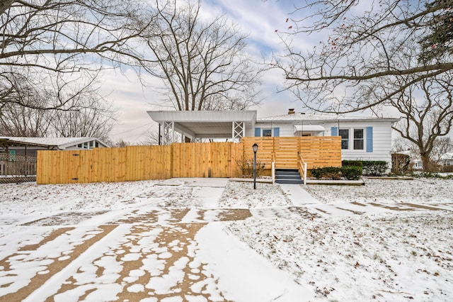 view of snow covered back of property