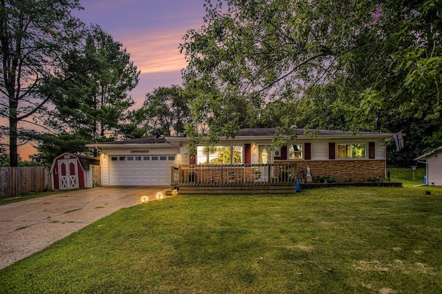 ranch-style house with a yard and a garage