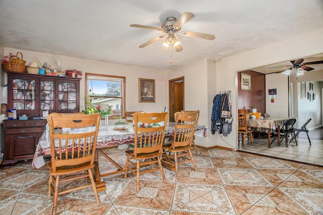 dining space featuring ceiling fan and light tile patterned floors