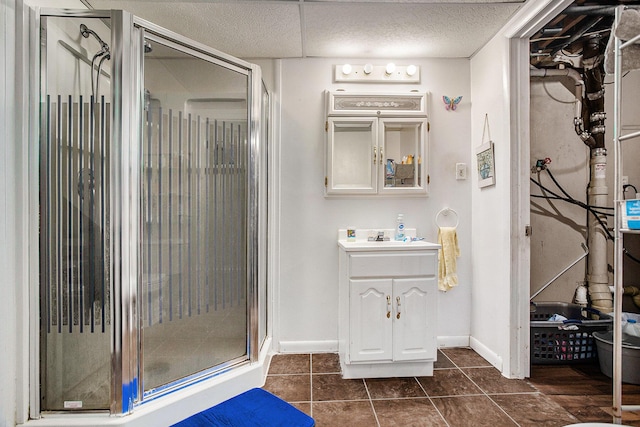 bathroom with tile patterned flooring, vanity, and an enclosed shower