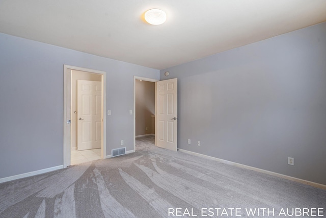 unfurnished bedroom with light carpet