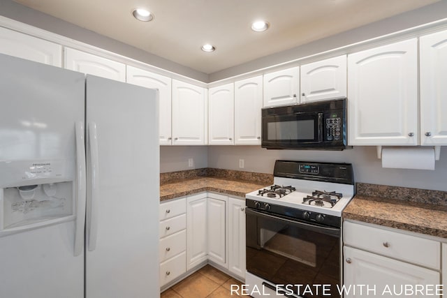 kitchen with white cabinetry, white fridge with ice dispenser, light tile patterned floors, and gas stove