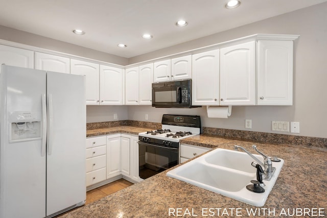 kitchen featuring white cabinets, light tile patterned floors, sink, and white appliances