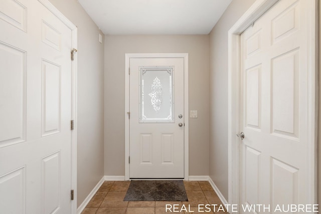 doorway to outside with tile patterned flooring