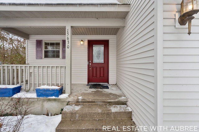 view of exterior entry with covered porch