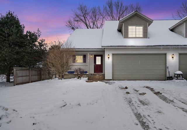 new england style home featuring a garage