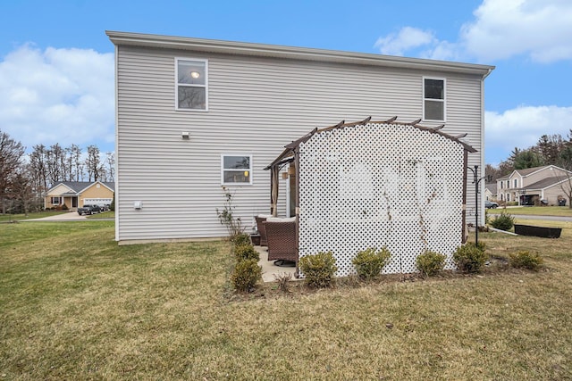 rear view of house with a yard