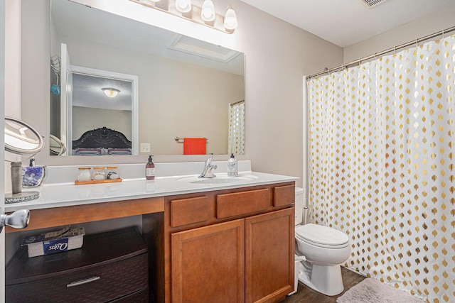 bathroom with vanity, hardwood / wood-style flooring, and toilet