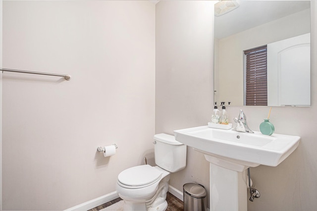 bathroom featuring hardwood / wood-style floors and toilet