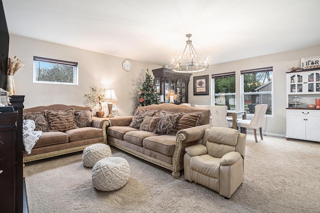 living room featuring carpet floors and an inviting chandelier