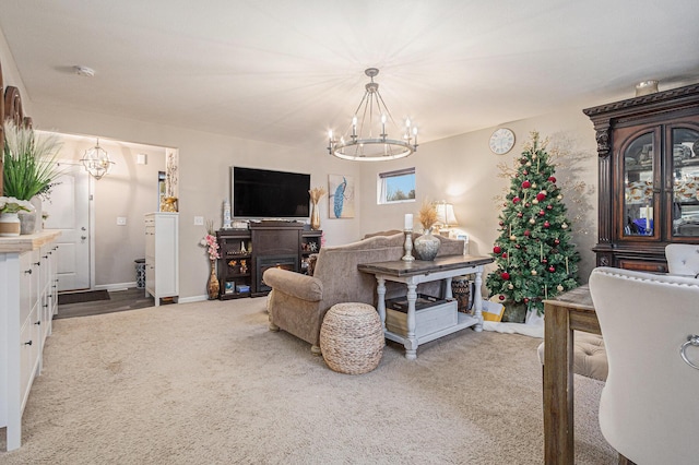 living room featuring carpet floors and a notable chandelier