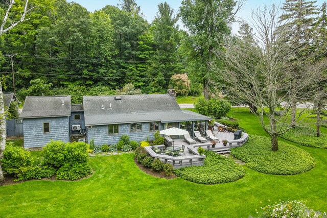 back of house featuring a lawn and a patio area