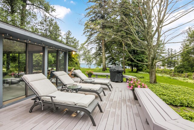 deck featuring area for grilling and a sunroom