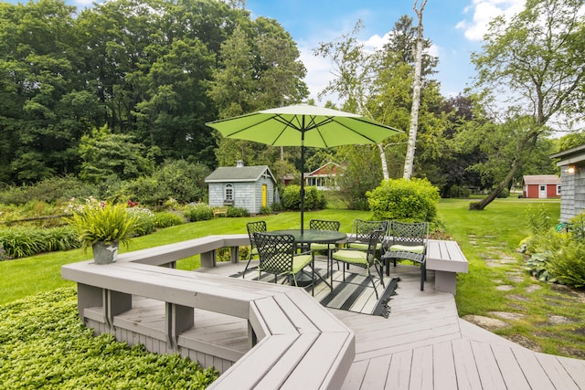 wooden terrace with an outbuilding and a lawn