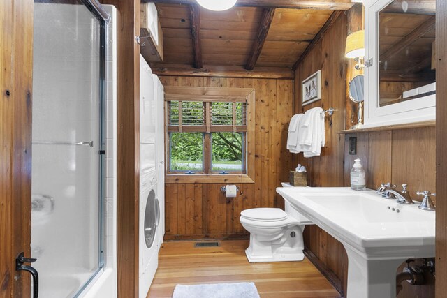 bathroom featuring beamed ceiling, an enclosed shower, wooden walls, wood ceiling, and hardwood / wood-style flooring