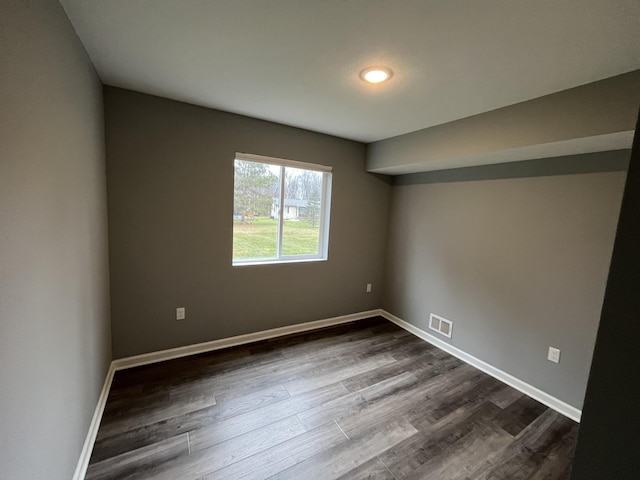 unfurnished room featuring dark hardwood / wood-style flooring