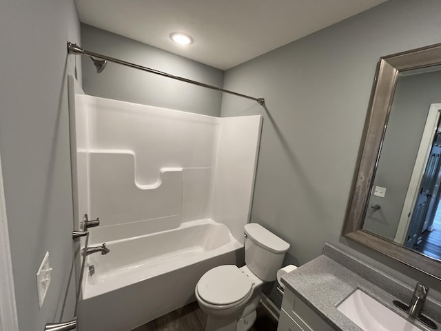 full bathroom featuring hardwood / wood-style floors, vanity, shower / bathtub combination, and toilet