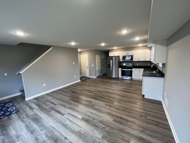 kitchen with white cabinets, stainless steel appliances, dark wood-type flooring, and sink