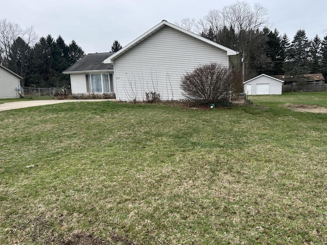 view of side of property with a yard and an outbuilding