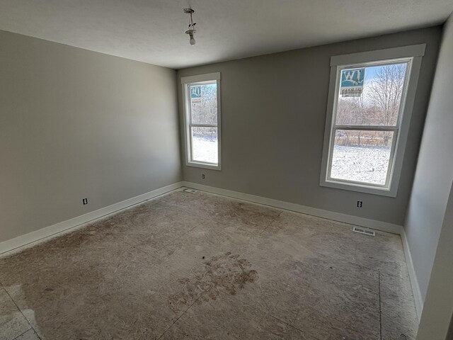 unfurnished room featuring a wealth of natural light