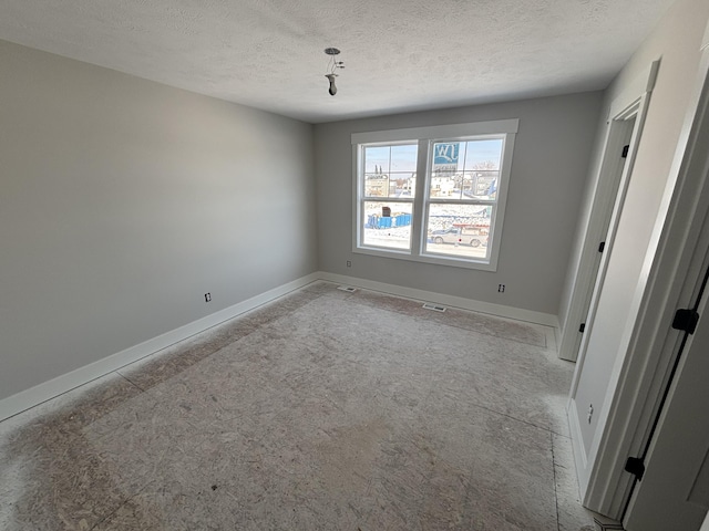 spare room featuring a textured ceiling