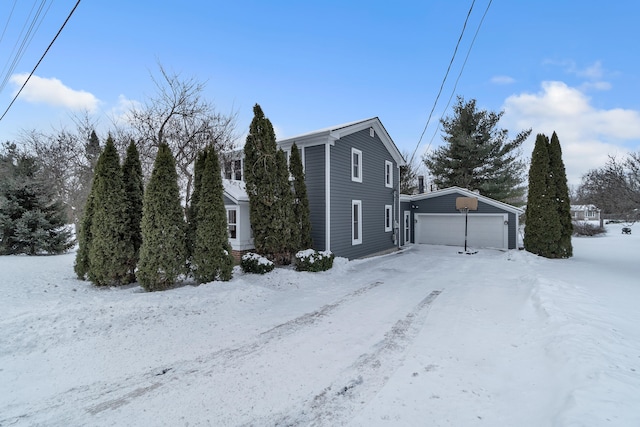 snow covered property featuring a garage