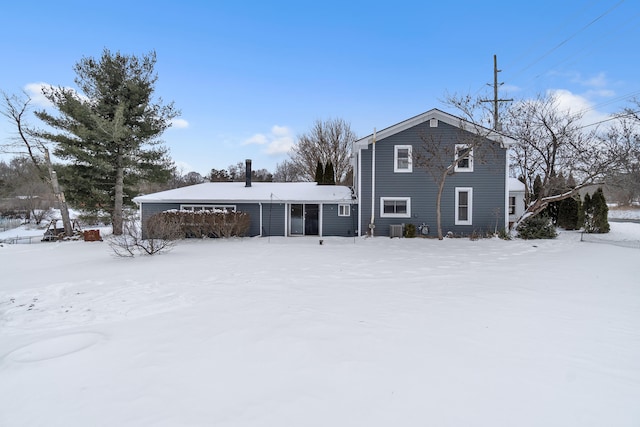 snow covered property featuring central AC unit