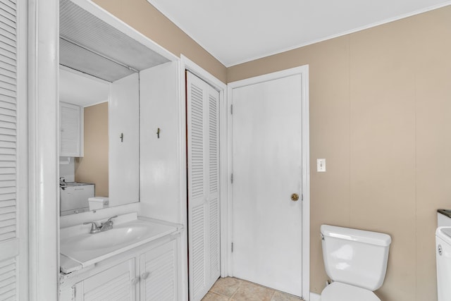 bathroom with tile patterned flooring, a closet, vanity, and toilet