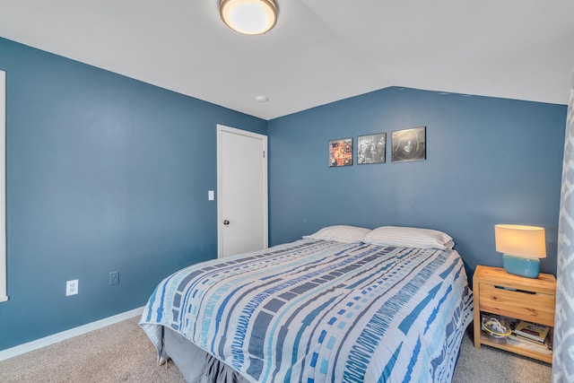 bedroom with light carpet, baseboards, and lofted ceiling