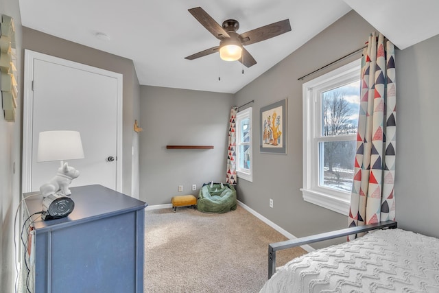 carpeted bedroom featuring baseboards and a ceiling fan